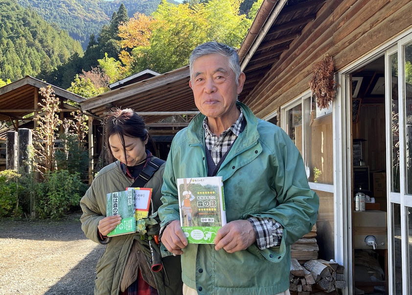 Soji Tanaka and his daughter-in-law, Chiyoko, with books Tanaka wrote for children during the 54 years he worked in Hinohara's forests. 