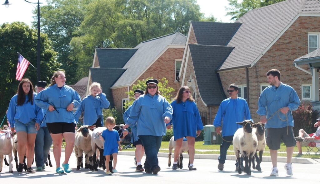 The procession of sheep and people in traditional herdsman’s attire is a tradition during Luxembourg Fest Week in Belgium, Wis.