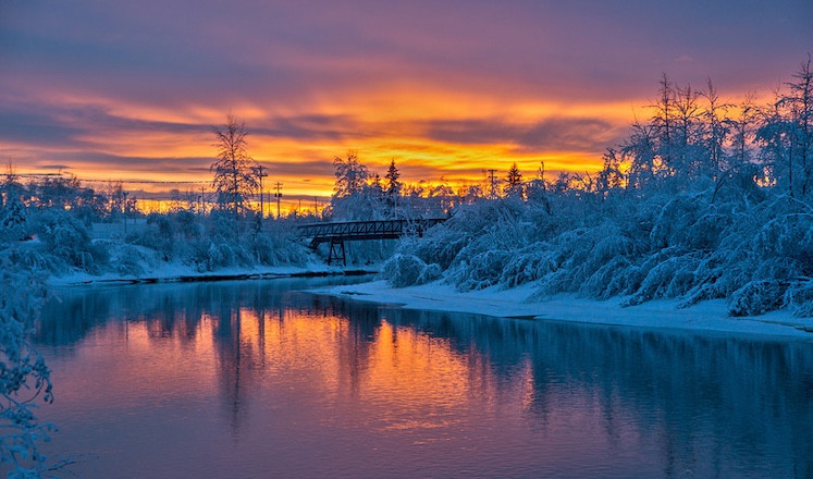 Winter is far from pale and colorless in Fairbanks—witness this sunset over the Chena River.