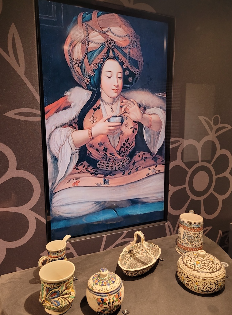 Woman dressed in Ottoman finery drinking Turkish coffee. Pera Museum, Istanbul 