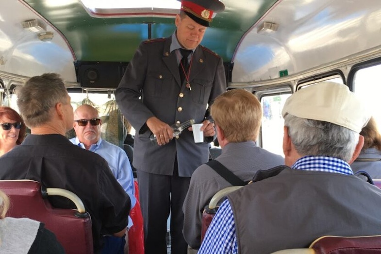 Western travelers in Tallinn, Estonia take a tour back in time to see what life was like under Soviet occupation. Tour guide Olavi Andla serves "Soviet morning coffee (aka vodka shots) to get the day started. 