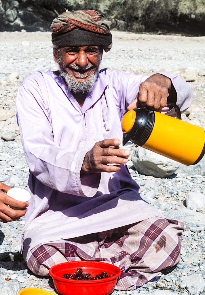 Khalid, the foreman of the falaj cleaning crew in Oman's Wadi Bani Kharus, pours coffee for unexpected guests. 