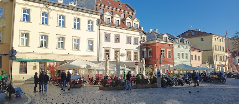 Sidewalk cafes line Rynek Glowny in Old Town Krakow.